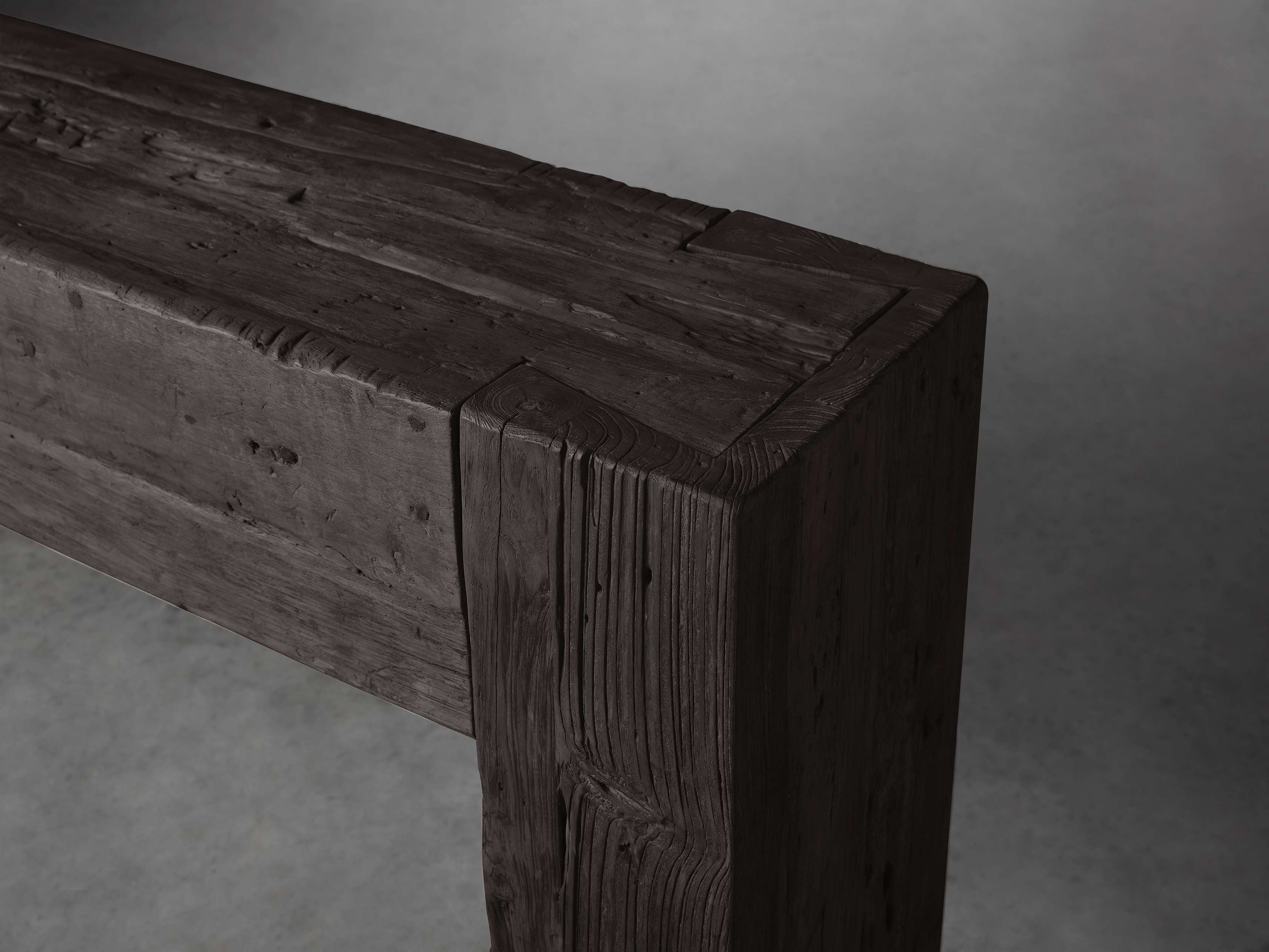 Close-up of the corner of the Ubud Console made of reclaimed teak wood with visible grain and gray finish, showcasing rustic craftsmanship.
