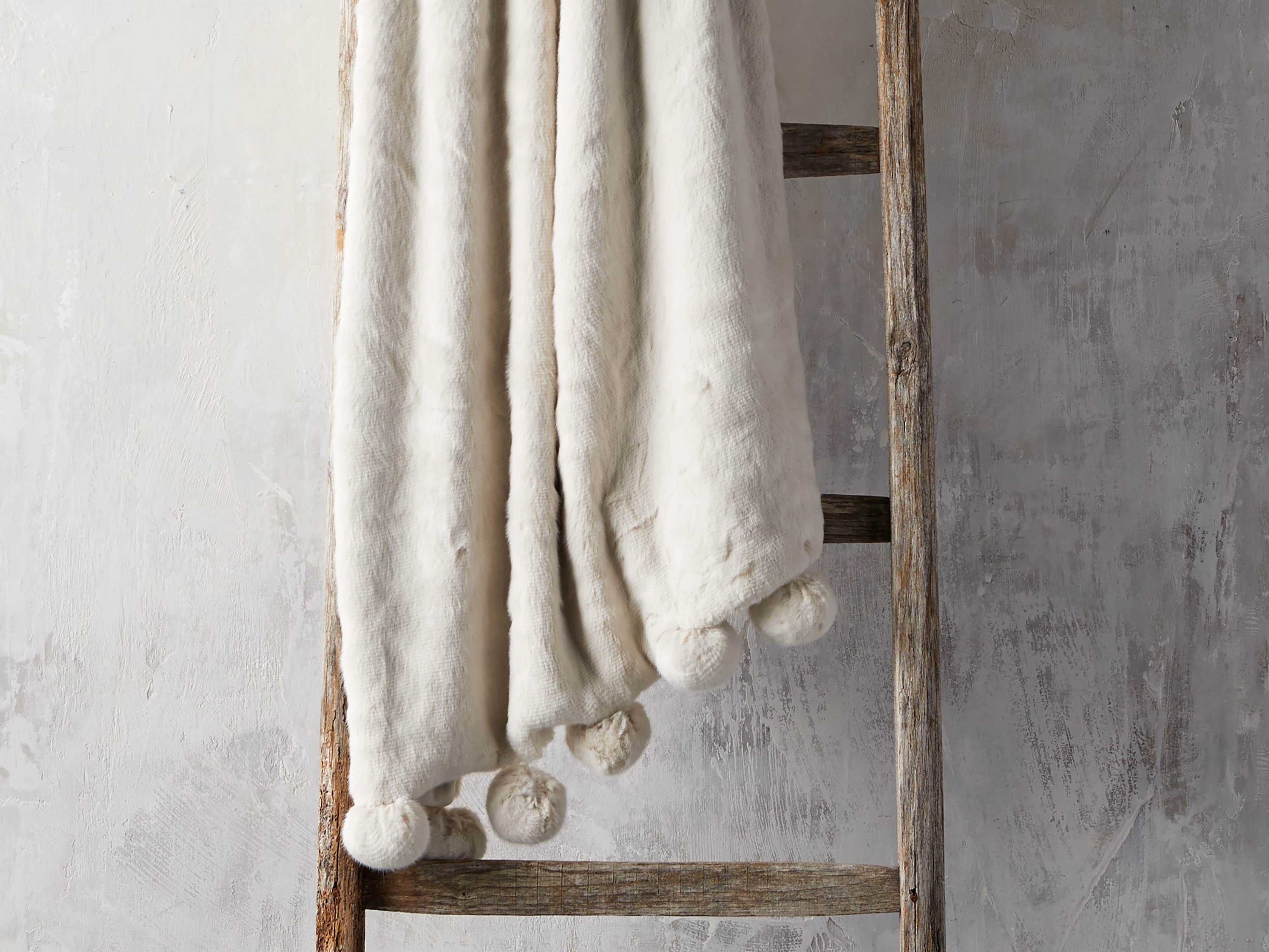 Faux Fur Pom Throw in Ivory - Charming white home exteriors as well as neutral decor finds at Arhaus. 