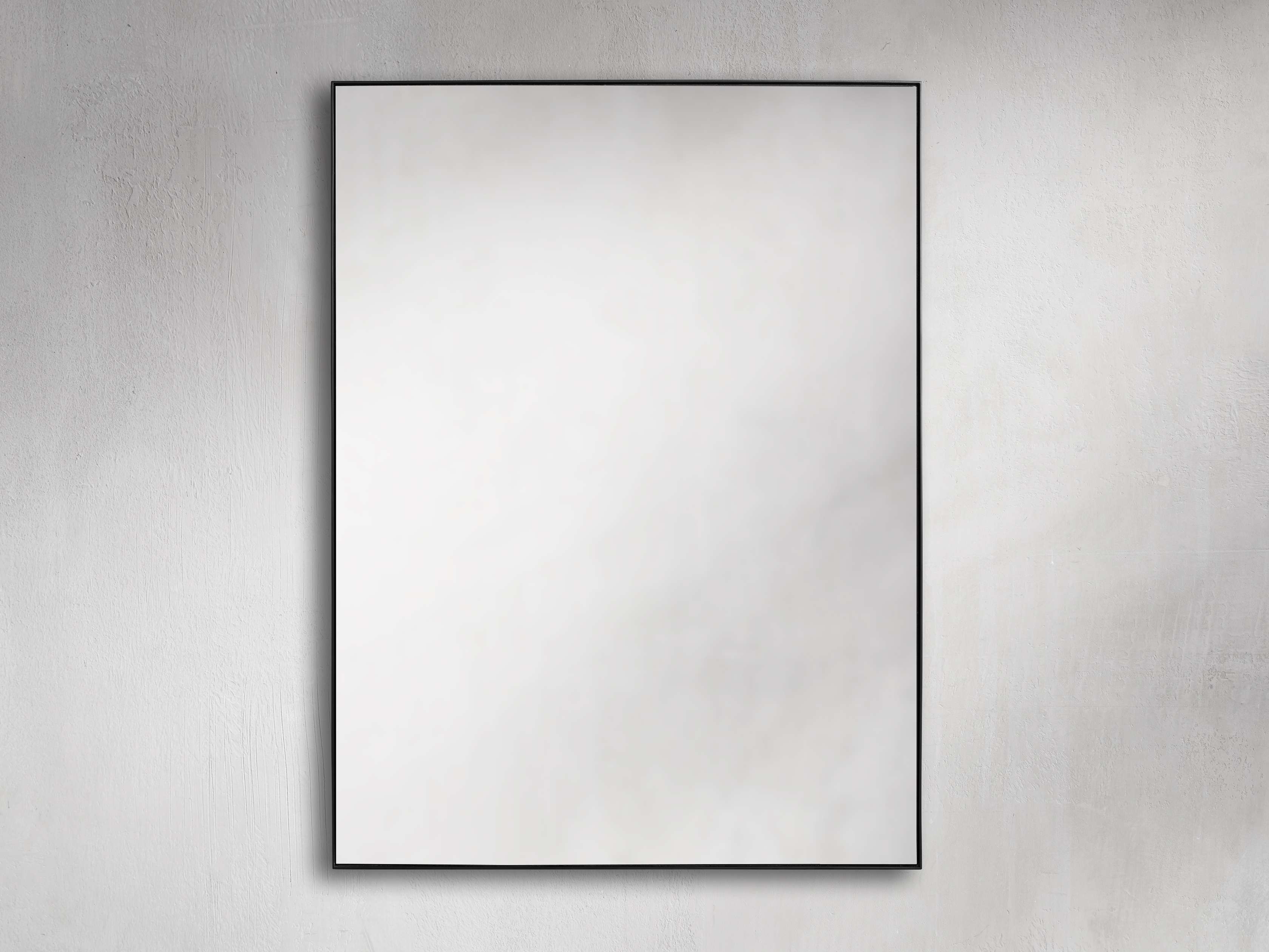 Rectangular wall mirror with a black minimalist steel frame, mounted on a textured neutral-colored wall.