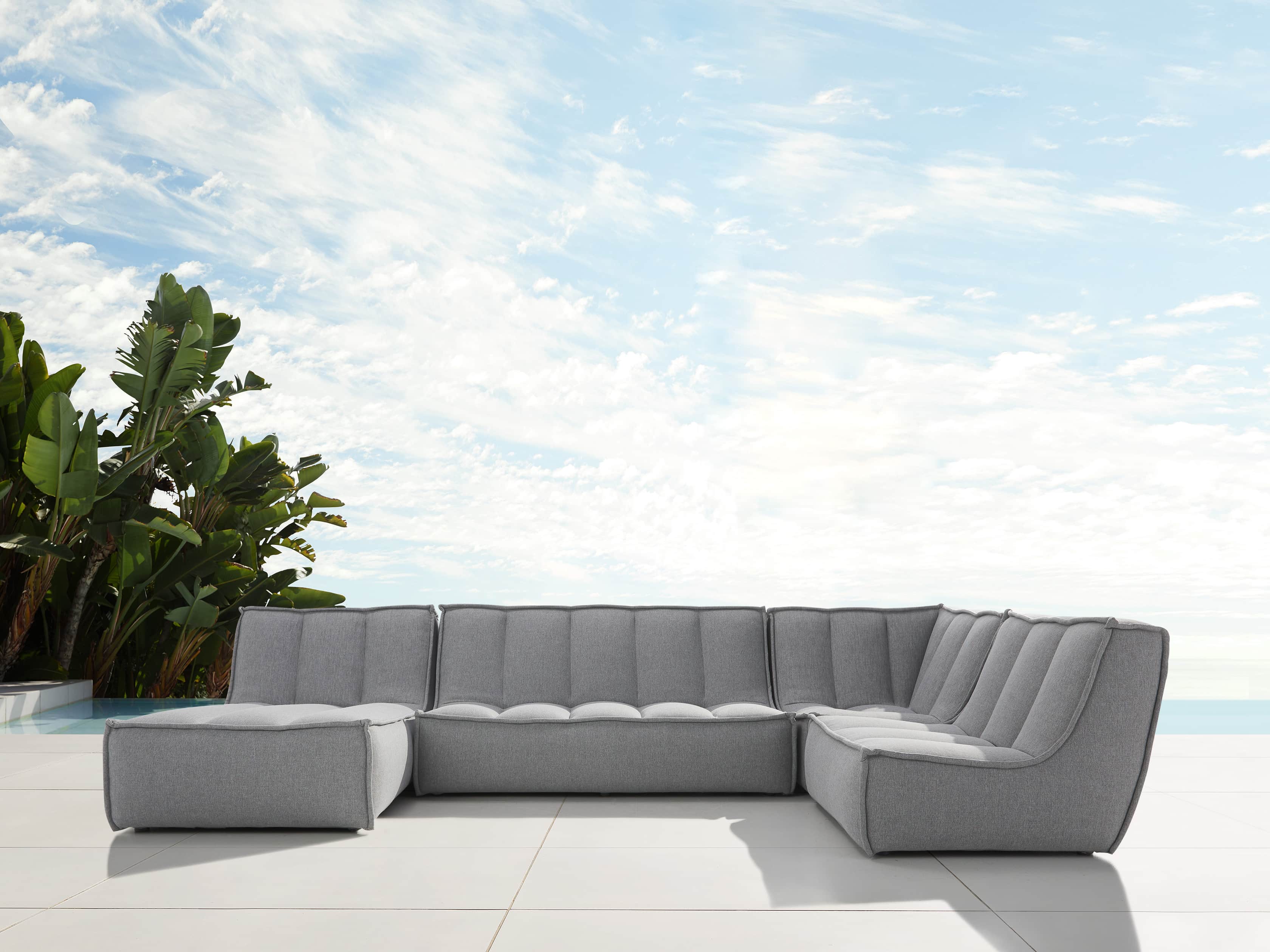 Porto Outdoor Upholstered 135" Four Piece Sectional in Southend Grey