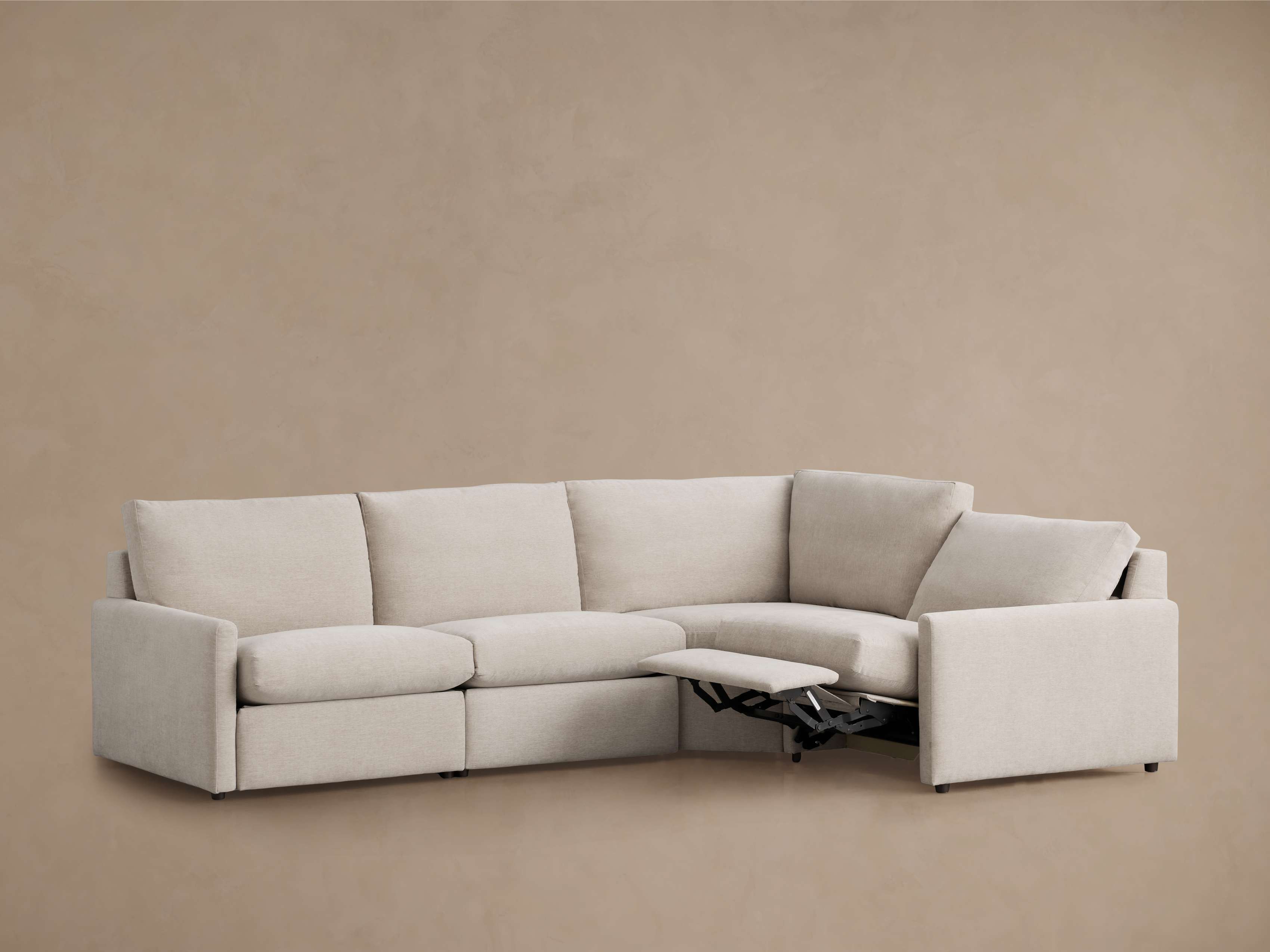 Close-up of fabric upholstery on the armrest and cushions showing soft, neutral beige linen-like fabric.