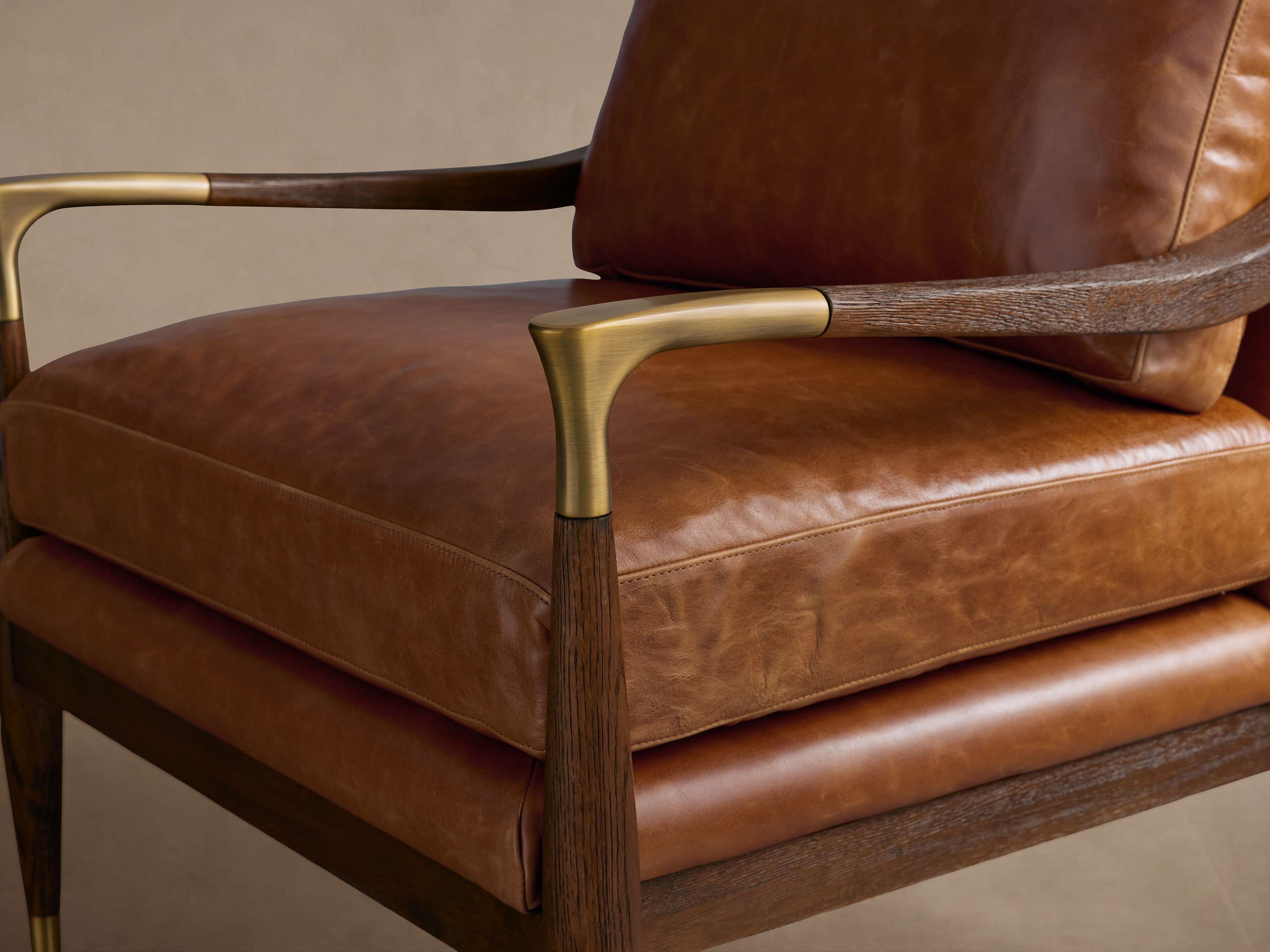 Close-up of brown leather chair arm and seat