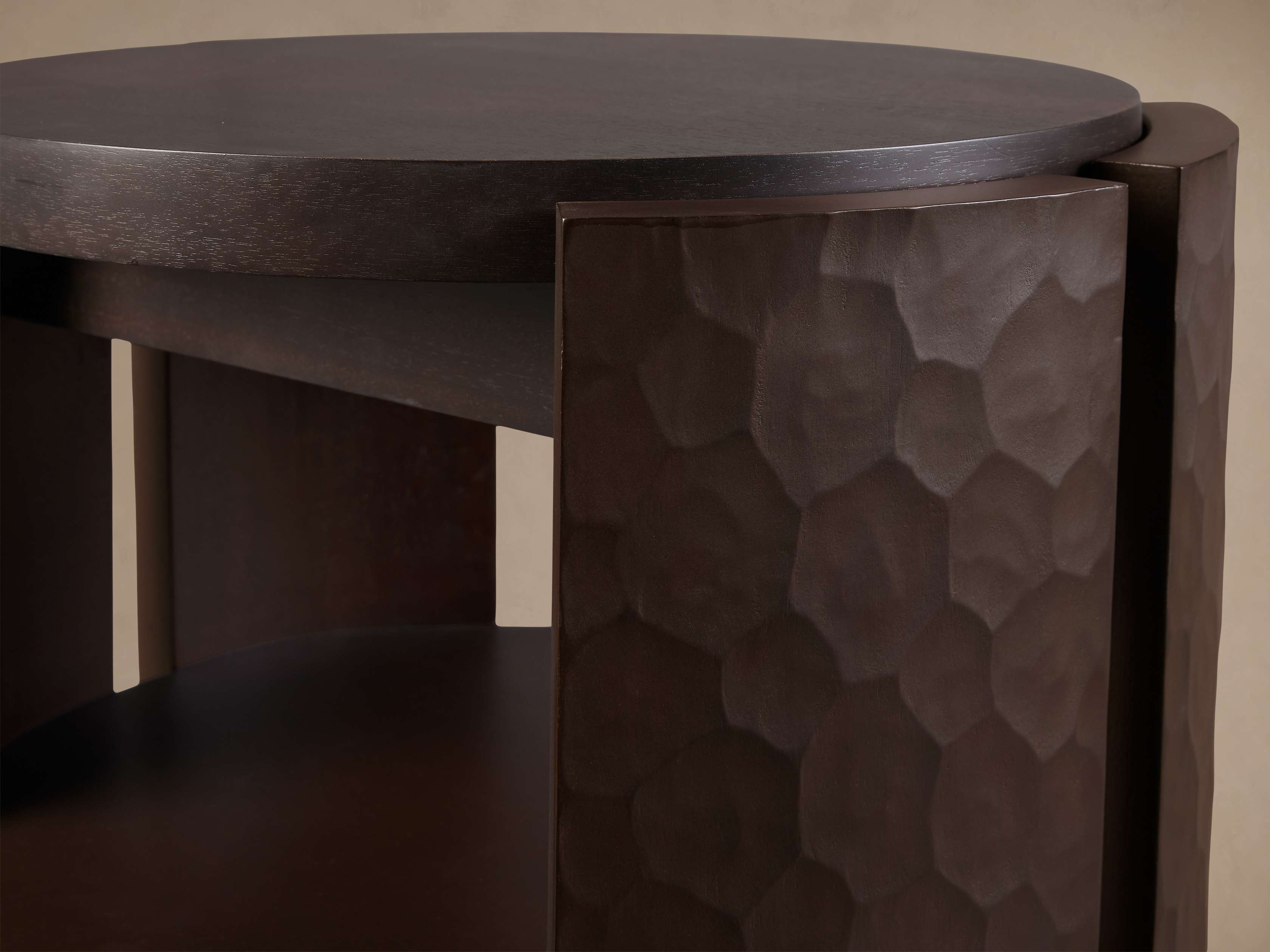 Close-up of the table edge and textured side panel, showing hammer-like pattern on wood.