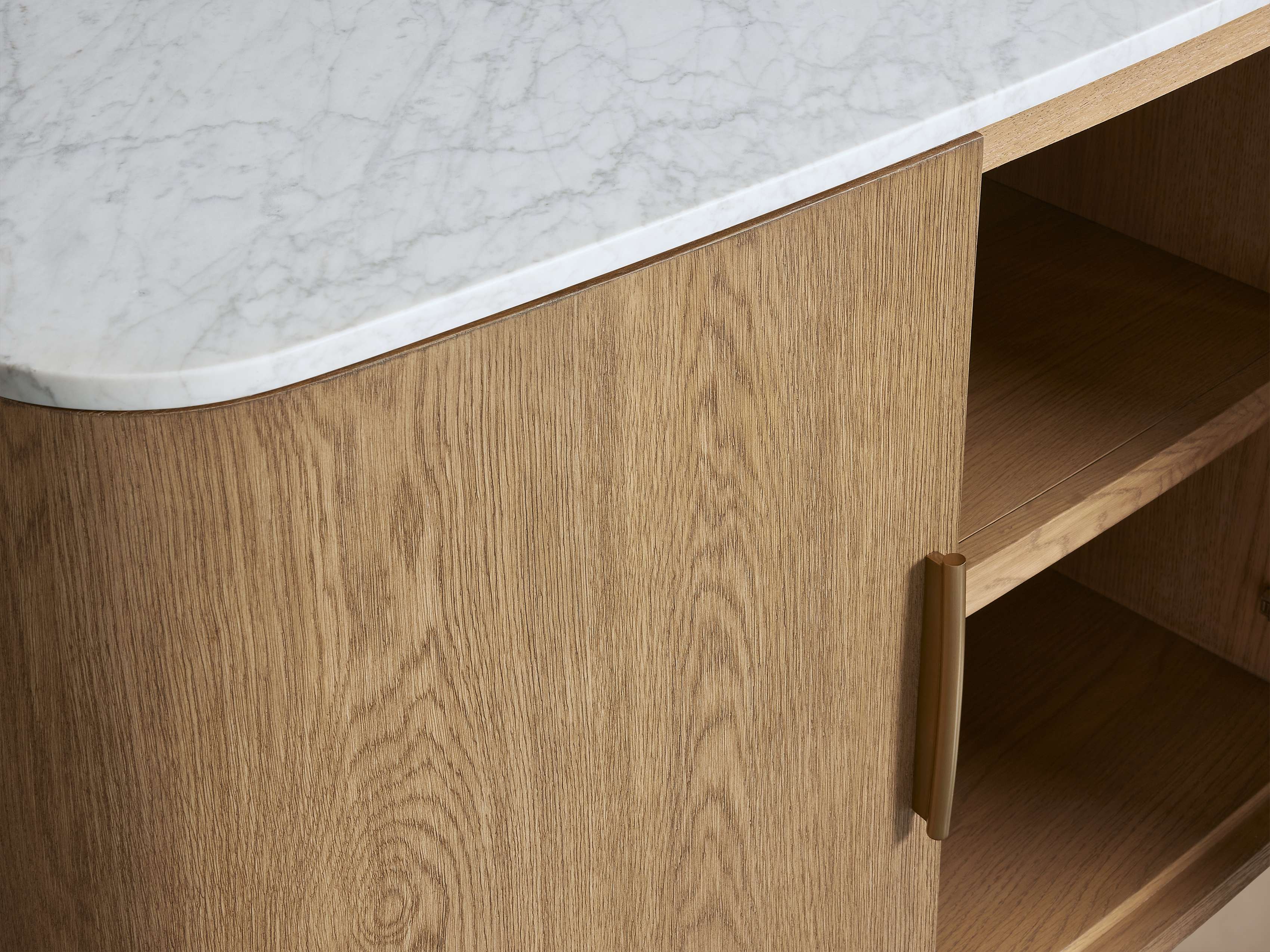 A close-up of a wooden cabinet with a marble countertop, showing the texture of the wood and the smooth surface of the marble.