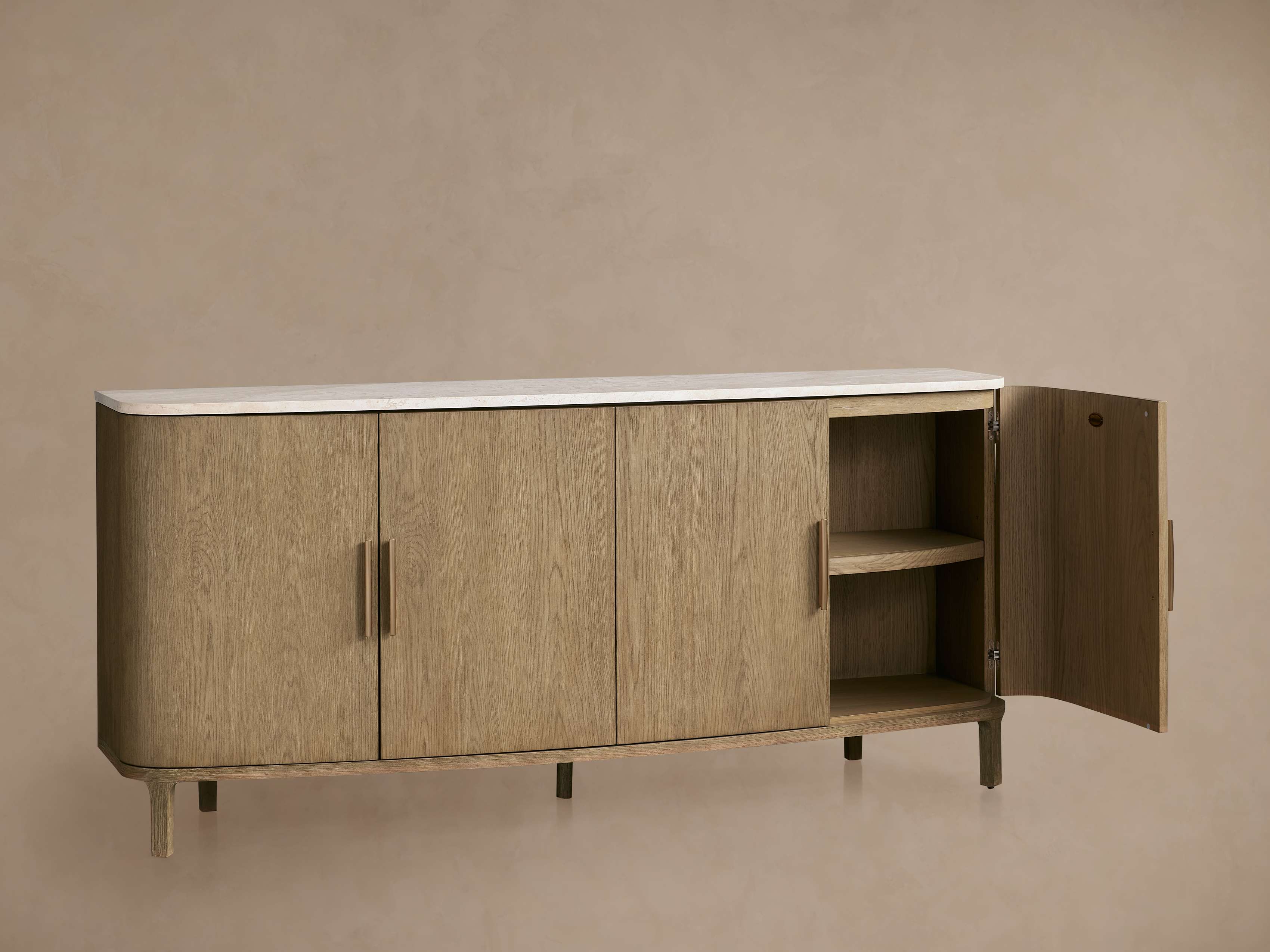 A light brown wooden sideboard with a white marble top and one open door, showing the interior shelves.