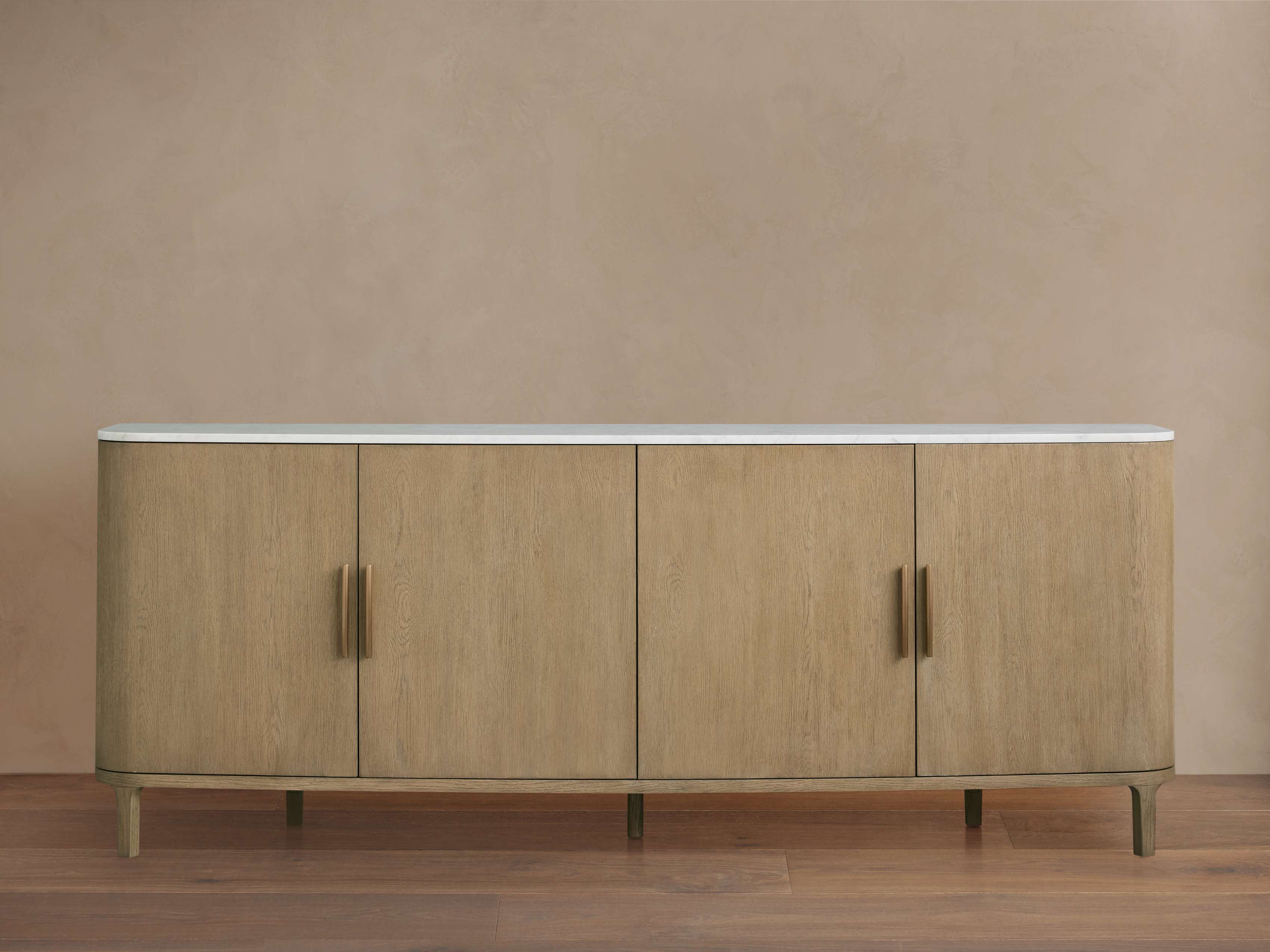A full view of a sideboard with four doors and a white marble top.