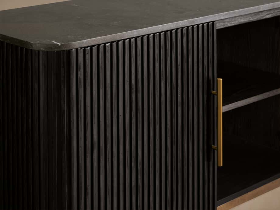 Finnley Media Console with ribbed, dark wood finish, brass handle, dark stone top, and open shelving visible on the right.