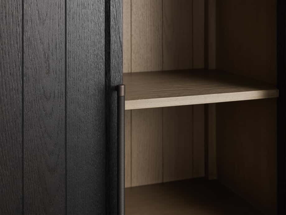 Hattie Cabinet close-up showing dark oak door with reeded handle, exposed hinge, and light shiplap interior with shelf.