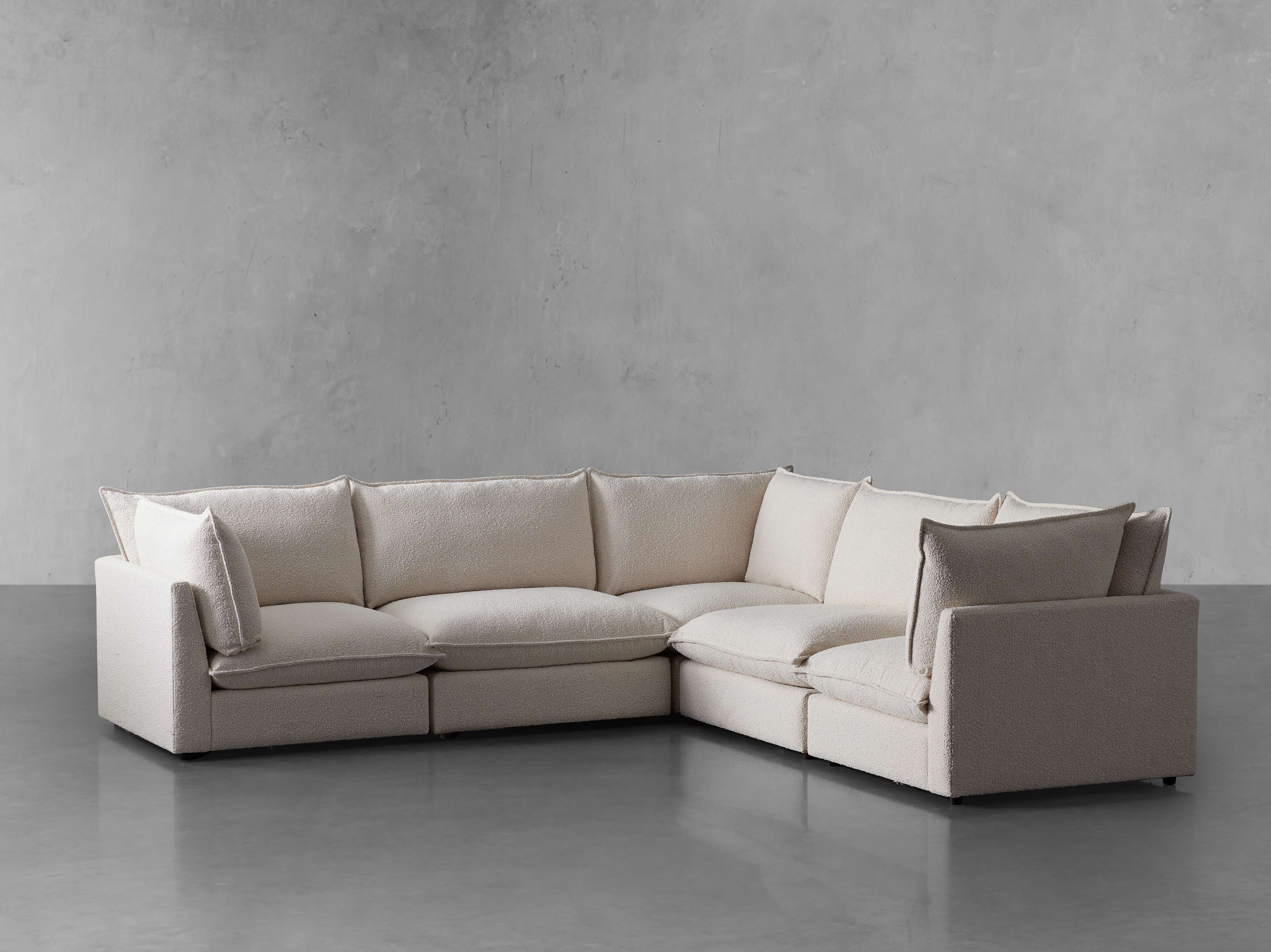 A beige sectional sofa with a chaise lounge on the right side from a different angle.